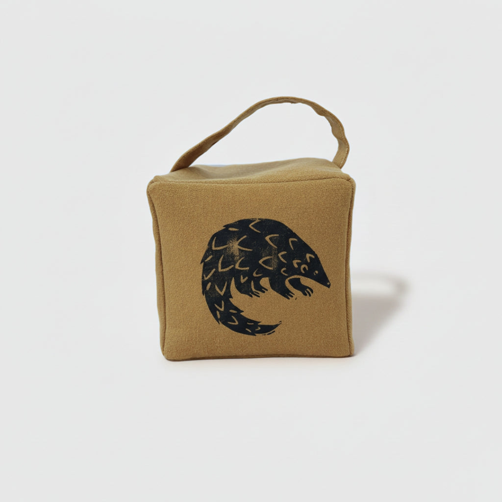 Rolo the pangolin doorstop in ochre