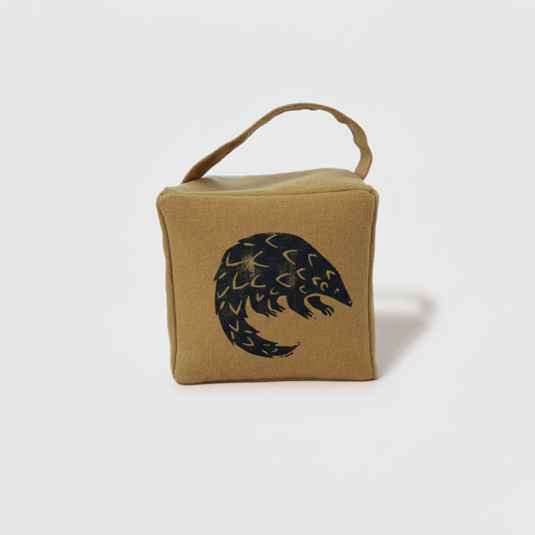 Rolo the pangolin doorstop in ochre