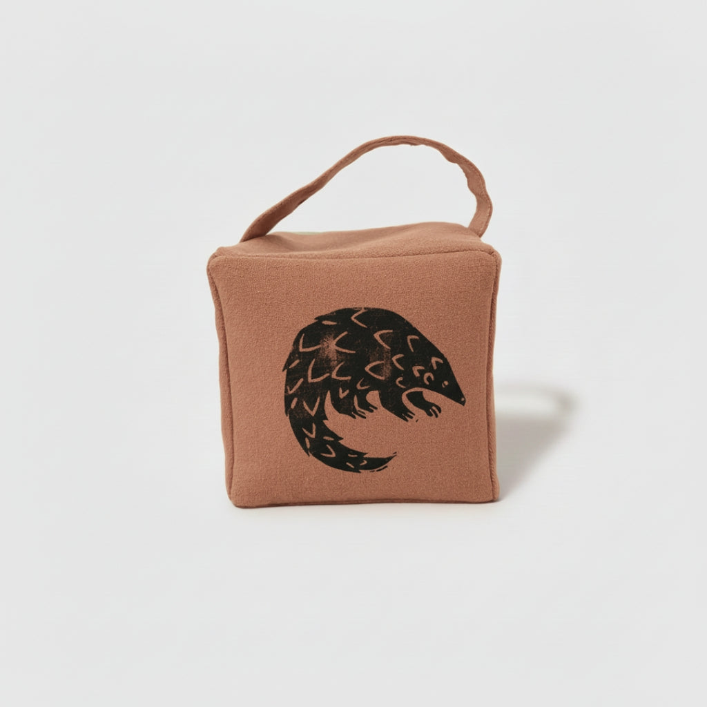 Rolo the pangolin doorstop in terracotta