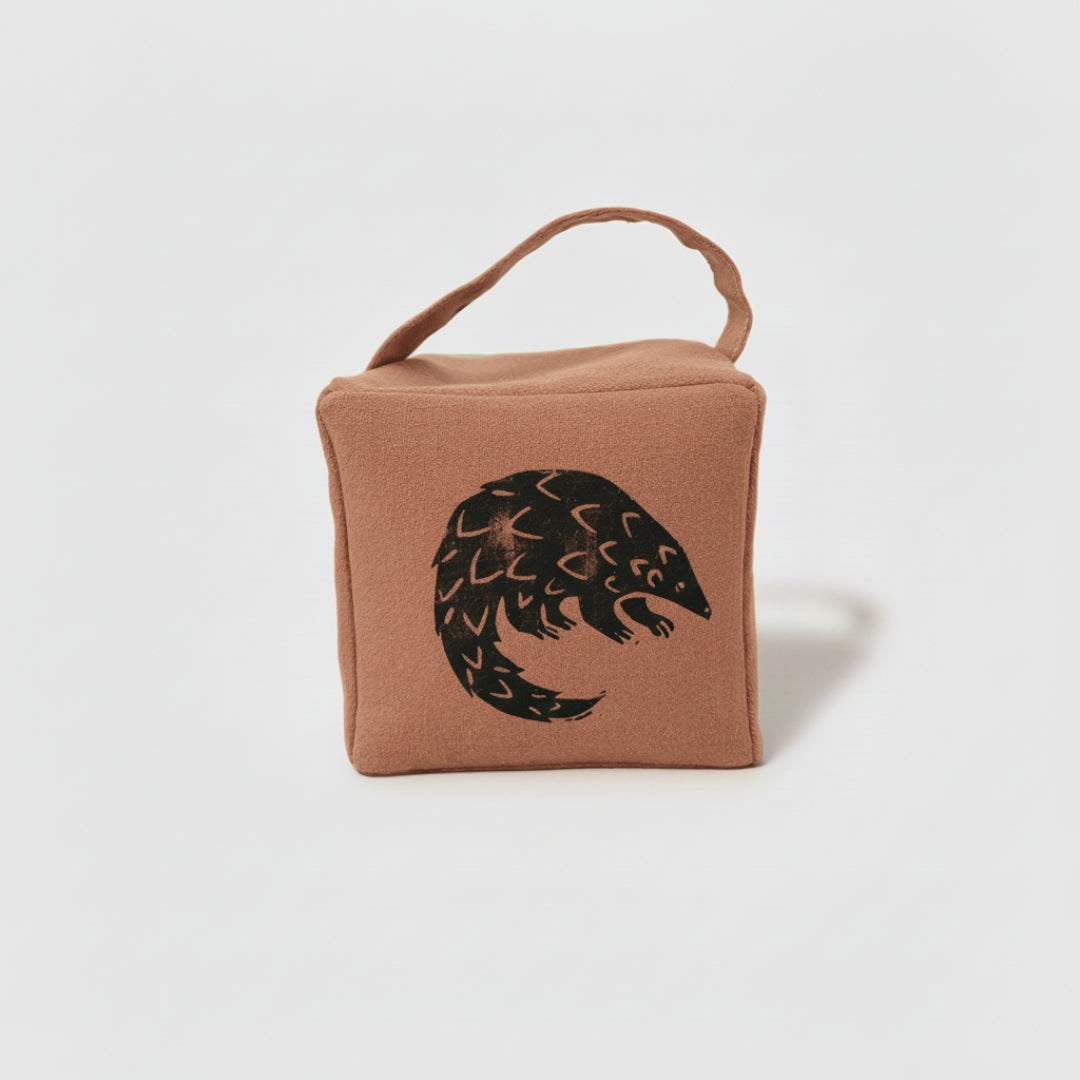 Rolo the pangolin doorstop in terracotta