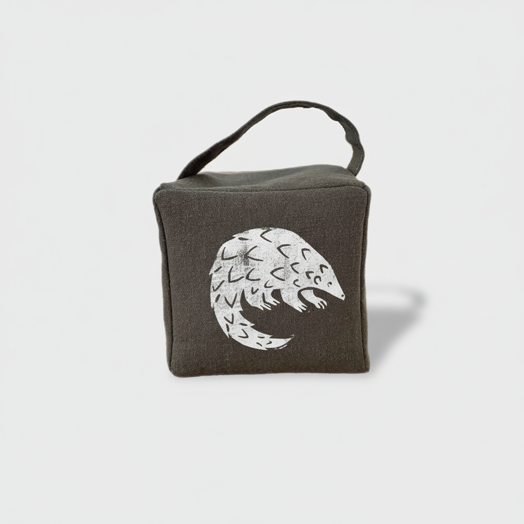 Charcoal Rolo pangolin doorstop with white ink - front view
