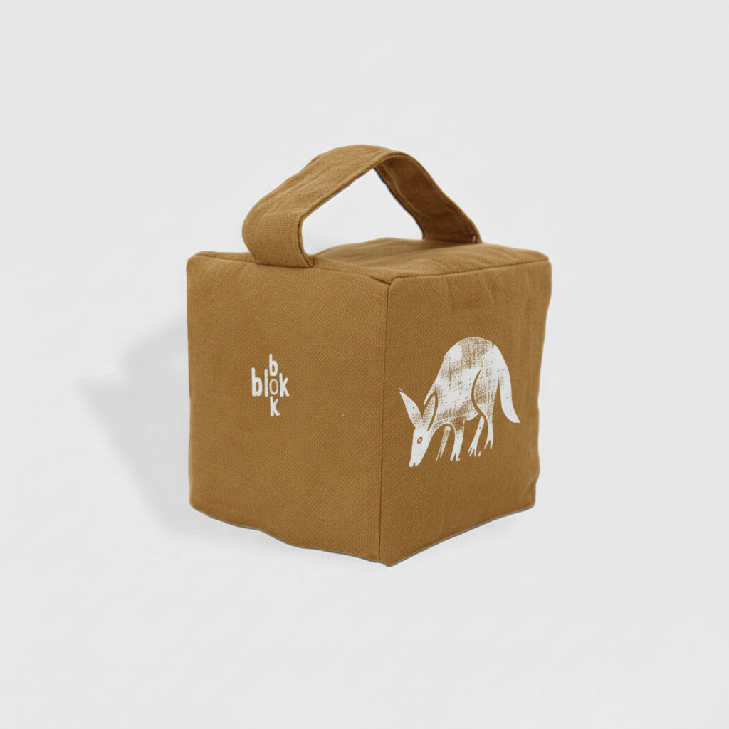 Muted ochre aardvark doorstop with white ink - angled view